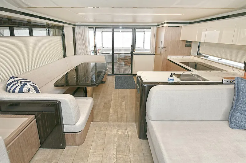  Yacht Photos Pics Luxurious interior of 2022 Absolute 62 Fly yacht with modern seating and kitchen area.