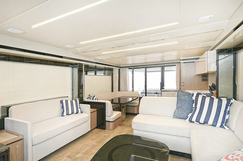  Yacht Photos Pics Luxurious interior of 2022 Absolute 62 Fly yacht with modern seating and striped cushions.