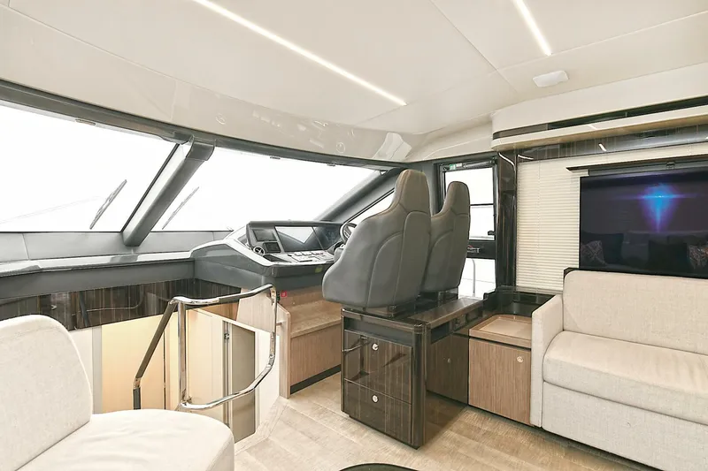  Yacht Photos Pics Luxurious interior of 2022 Absolute 62 Fly yacht with modern seating and navigation area.