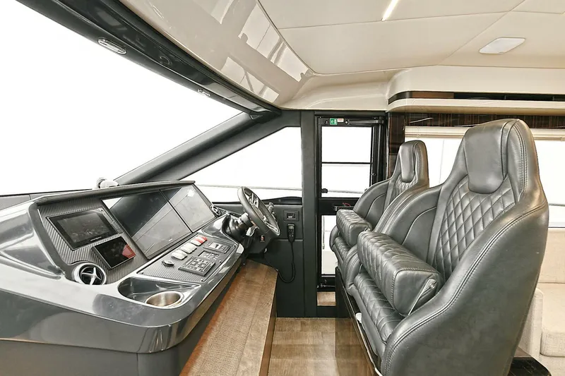  Yacht Photos Pics Luxurious interior of 2022 Absolute 62 Fly yacht with leather seating and modern dashboard.