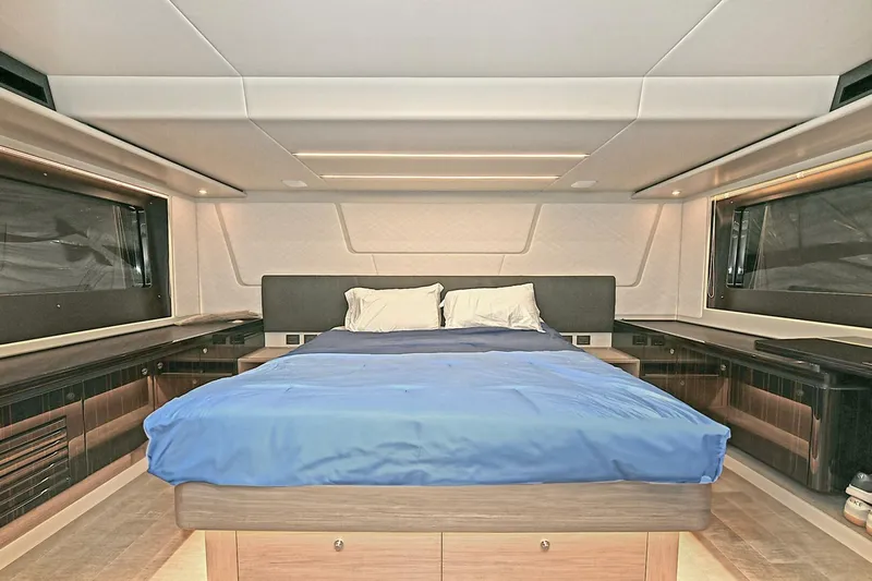  Yacht Photos Pics Luxurious bedroom interior of 2022 Absolute 62 Fly yacht with modern design and large windows.