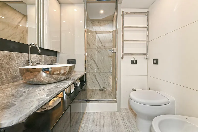  Yacht Photos Pics Luxurious bathroom in 2022 Absolute 62 Fly yacht with modern fixtures and marble accents.