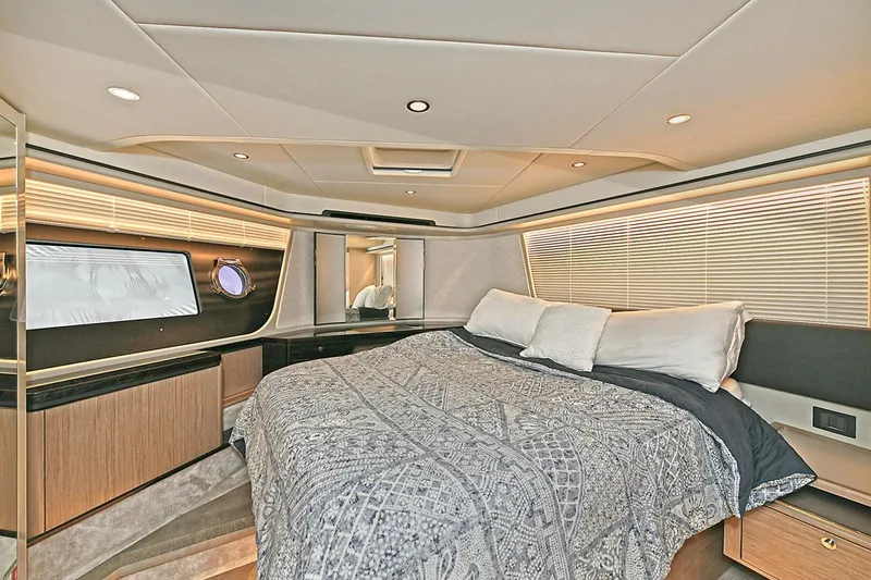  Yacht Photos Pics Luxurious bedroom interior of 2022 Absolute 62 Fly yacht with modern design and cozy bedding.