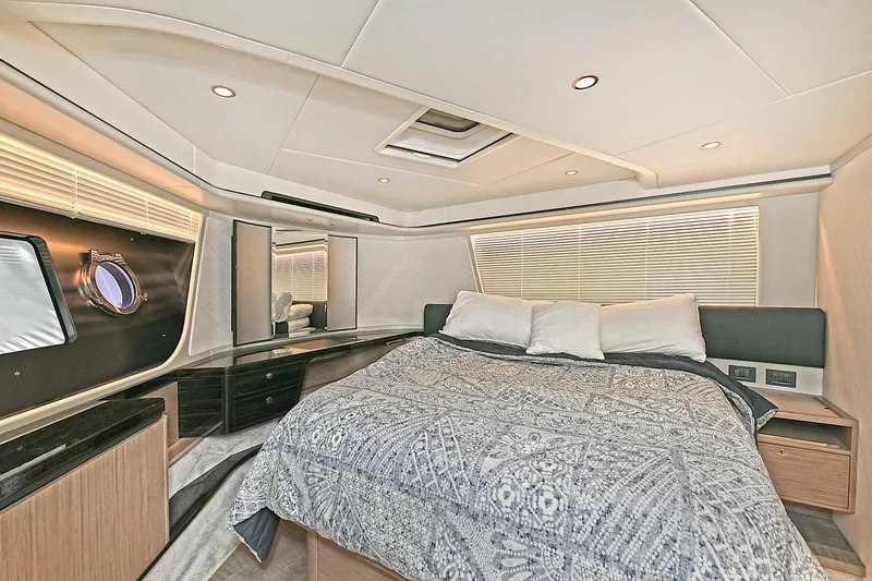  Yacht Photos Pics Luxurious bedroom interior of 2022 Absolute 62 Fly yacht with modern design and cozy bedding.