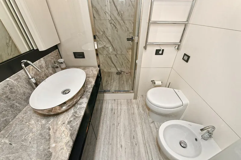  Yacht Photos Pics Luxurious bathroom in 2022 Absolute 62 Fly yacht with marble sink and modern fixtures.
