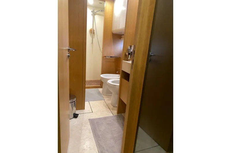  Yacht Photos Pics Bathroom interior of 2011 Sanlorenzo SL62 yacht, featuring modern fixtures and wooden accents.