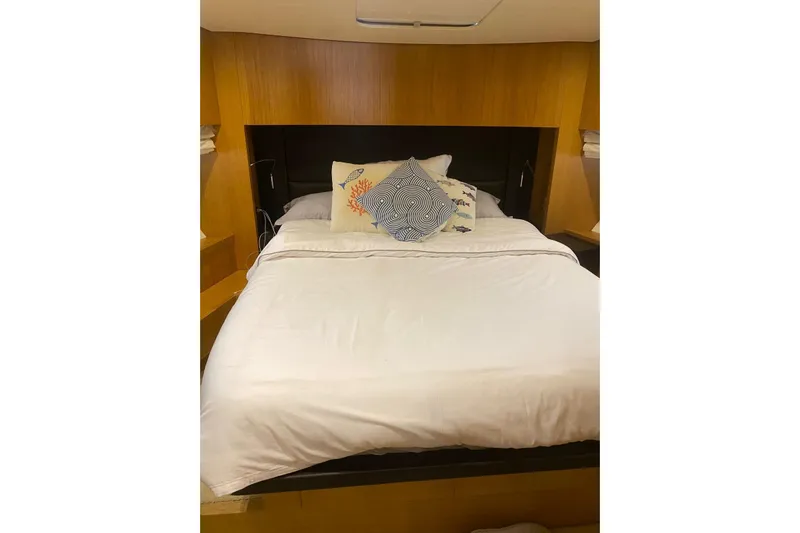  Yacht Photos Pics Luxurious bedroom interior of 2011 Sanlorenzo SL62 yacht with cozy bedding and decorative pillows.