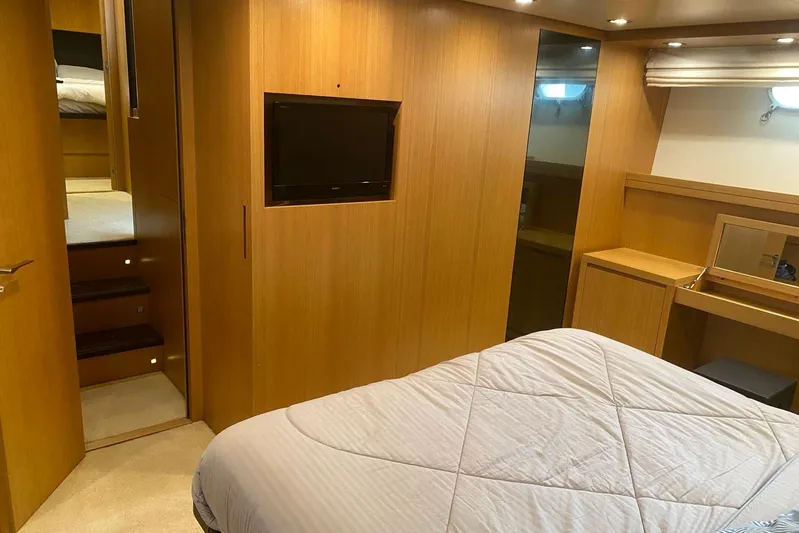  Yacht Photos Pics Luxurious cabin interior of 2011 Sanlorenzo SL62 yacht with wood paneling and modern amenities.