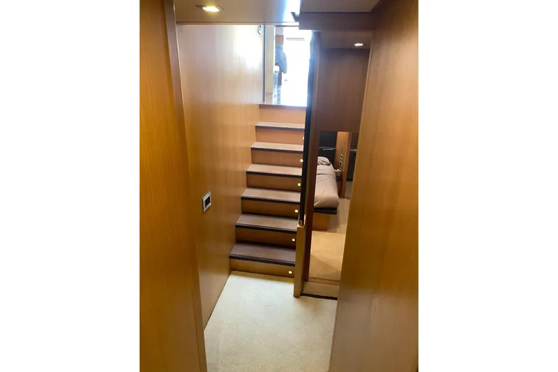 Yacht Photos Pics Interior view of 2011 Sanlorenzo SL62 yacht with wooden stairs and cozy cabin.