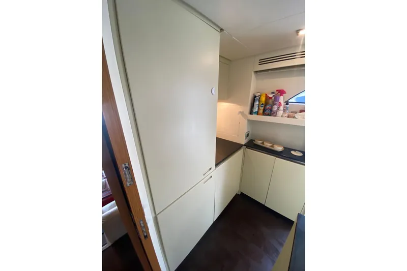 Yacht Photos Pics Compact kitchen area in a 2011 Sanlorenzo SL62 yacht, featuring modern cabinetry and storage.