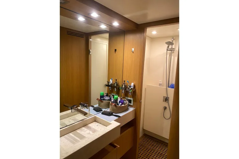  Yacht Photos Pics Luxurious bathroom on 2011 Sanlorenzo SL62 yacht with modern fixtures and wooden accents.