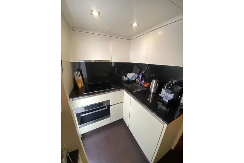  Yacht Photos Pics Modern kitchen in 2011 Sanlorenzo SL62 yacht with sleek black countertops.