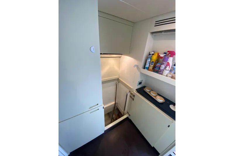  Yacht Photos Pics Compact storage area in 2011 Sanlorenzo SL62 yacht with cleaning supplies and cabinets.
