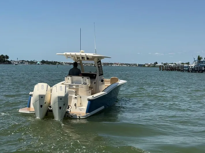  Yacht Photos Pics 2023 Scout 277 LXF boat cruising on a calm waterway with dual engines.