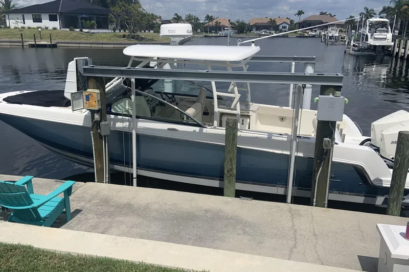  Yacht Photos Pics 2019 Boston Whaler 270 Vantage docked by a waterfront home.