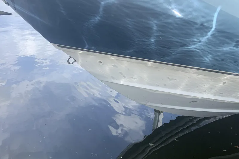 Yacht Photos Pics 2019 Boston Whaler 270 Vantage boat hull reflecting on calm water.
