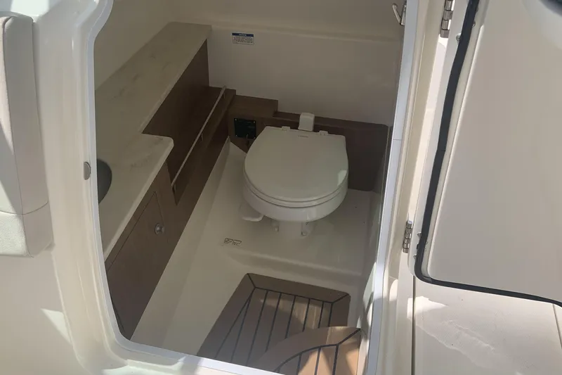  Yacht Photos Pics 2019 Boston Whaler 270 Vantage boat interior with toilet and storage.