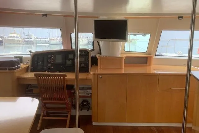  Yacht Photos Pics Interior of 2008 Fountaine Pajot Salina 48 catamaran with navigation station and wooden cabinetry.