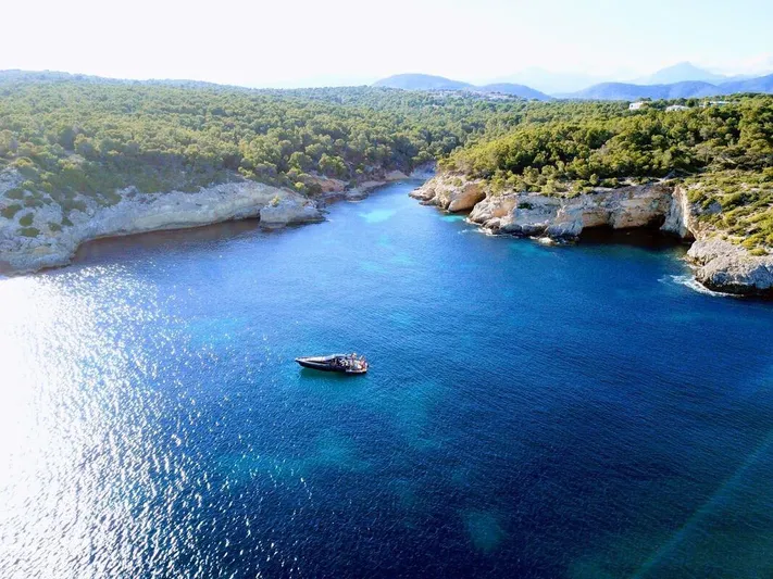 Anvera 48 Yacht Photos Pics Aerial view of Anvera 48 yacht in a serene coastal bay, surrounded by lush greenery, 2025.