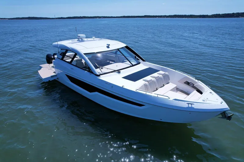  Yacht Photos Pics 2024 Cruisers Yachts 50 GLS luxury boat on calm blue water.