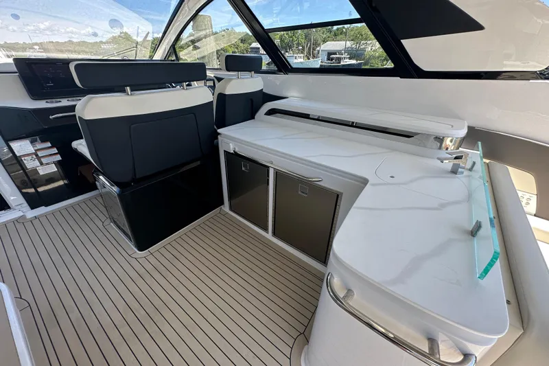  Yacht Photos Pics 2024 Cruisers Yachts 50 GLS interior with sleek seating and modern kitchenette.