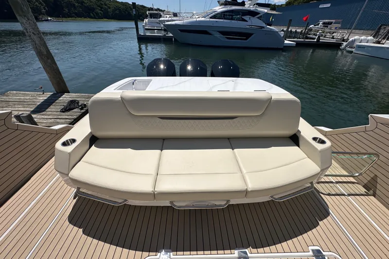  Yacht Photos Pics 2024 Cruisers Yachts 50 GLS luxury boat with spacious rear seating at a marina.