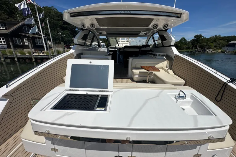  Yacht Photos Pics 2024 Cruisers Yachts 50 GLS luxury yacht interior with outdoor kitchen and seating area.