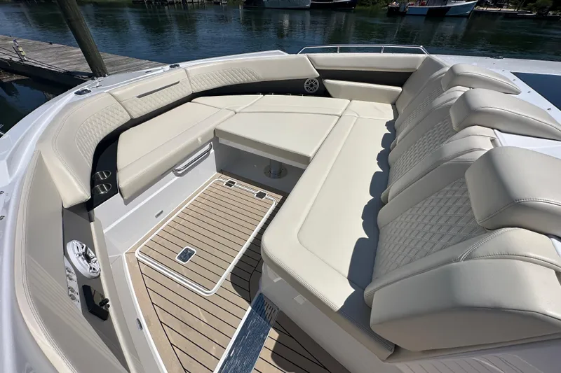  Yacht Photos Pics Luxurious seating area on 2024 Cruisers Yachts 50 GLS, featuring elegant upholstery and teak flooring.