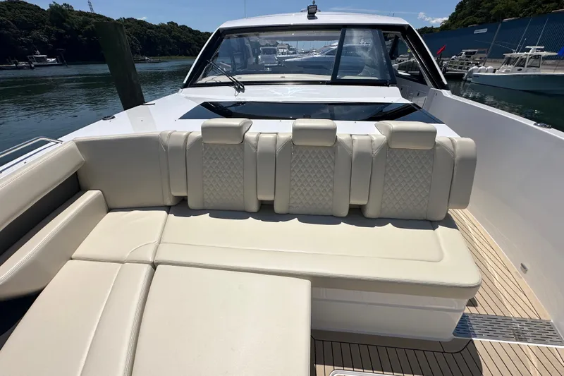  Yacht Photos Pics 2024 Cruisers Yachts 50 GLS luxury seating area with elegant upholstery and scenic marina view.