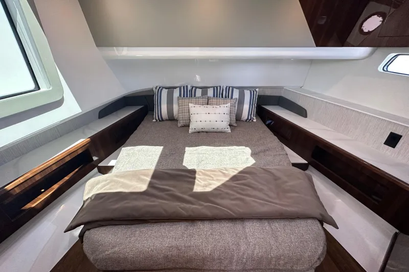  Yacht Photos Pics Luxurious cabin interior of 2024 Cruisers Yachts 50 GLS with cozy bedding and modern design.