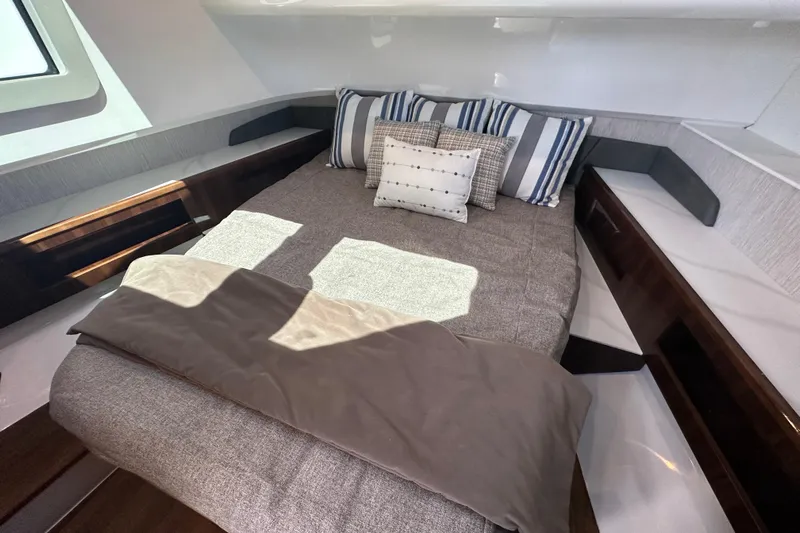  Yacht Photos Pics Luxurious cabin interior of 2024 Cruisers Yachts 50 GLS with stylish bedding and modern design.