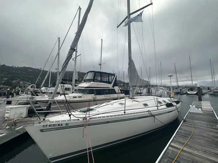 Ayla Yacht Photos Pics 1991 Beneteau First sailboat docked at a marina on a cloudy day.