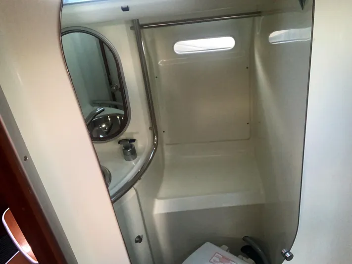 Ayla Yacht Photos Pics Bathroom interior of a 1991 Beneteau First sailboat, featuring a compact design with sink and mirror.