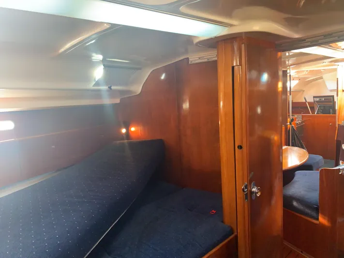 Ayla Yacht Photos Pics Interior of 1991 Beneteau First sailboat with wooden finish and cozy sleeping area.