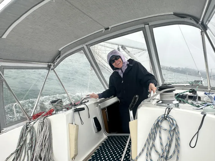 Ayla Yacht Photos Pics Person sailing a 1991 Beneteau First yacht on a cloudy day.