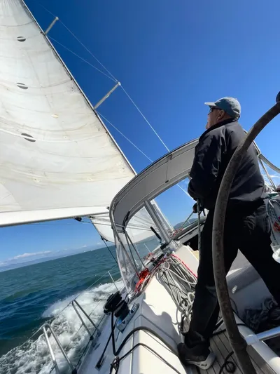 Ayla Yacht Photos Pics Person sailing a 1991 Beneteau First yacht on a sunny day.
