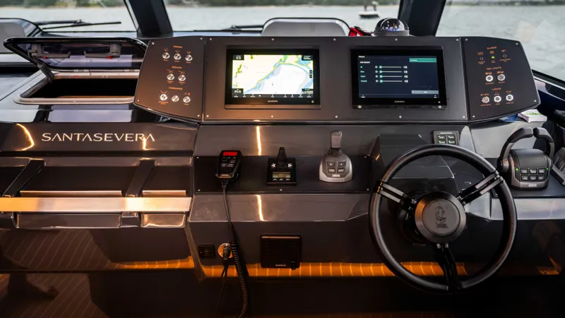  Yacht Photos Pics Control panel of 2026 Santasevera52 yacht with navigation screens and steering wheel.