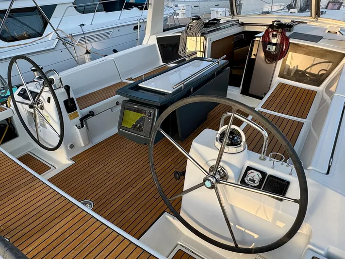 Sol Searcher Yacht Photos Pics Cockpit of 2013 Beneteau Oceanis 41 sailboat with dual steering wheels and teak flooring.