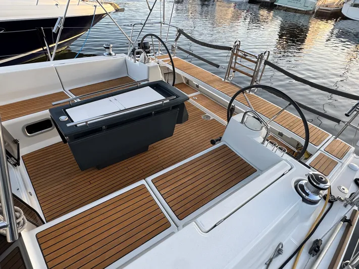 Sol Searcher Yacht Photos Pics Beneteau Oceanis 41 sailboat cockpit with dual steering wheels, teak decking, and marina view.