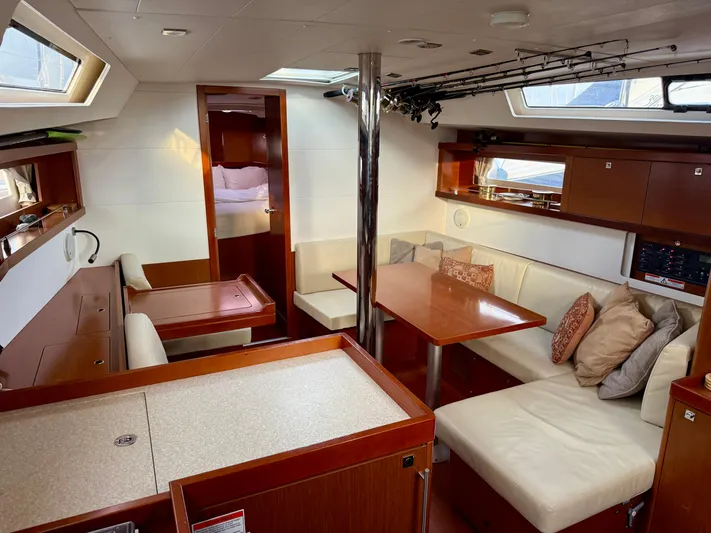 Sol Searcher Yacht Photos Pics Interior of 2013 Beneteau Oceanis 41 yacht with cozy seating and wooden finishes.