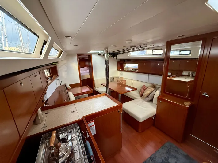 Sol Searcher Yacht Photos Pics Interior of 2013 Beneteau Oceanis 41 yacht with modern kitchen and cozy seating area.