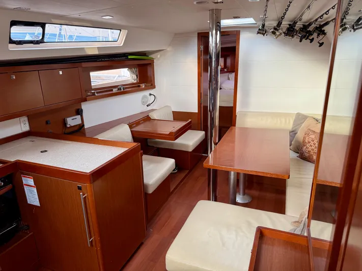 Sol Searcher Yacht Photos Pics Interior of 2013 Beneteau Oceanis 41 sailboat with wood finish and seating area.