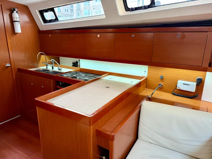 Sol Searcher Yacht Photos Pics Interior of 2013 Beneteau Oceanis 41 yacht, featuring modern kitchen and seating area.