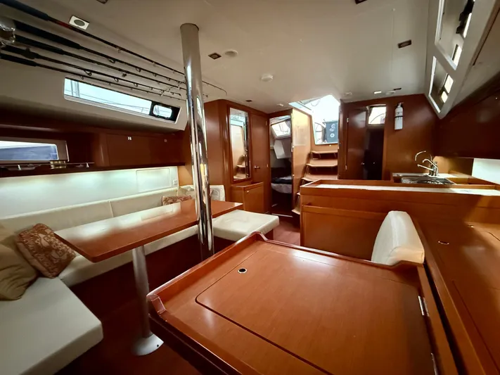 Sol Searcher Yacht Photos Pics Interior of 2013 Beneteau Oceanis 41 sailboat with wood finish and seating area.