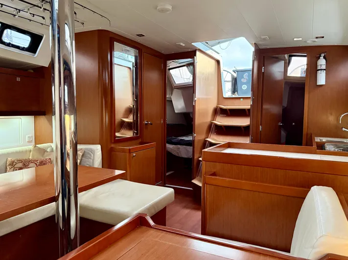 Sol Searcher Yacht Photos Pics Interior of 2013 Beneteau Oceanis 41 sailboat, featuring wood finish and cozy seating area.
