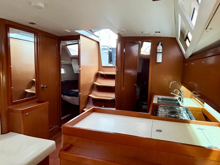 Sol Searcher Yacht Photos Pics Interior of 2013 Beneteau Oceanis 41 sailboat with wood finish and modern kitchen.