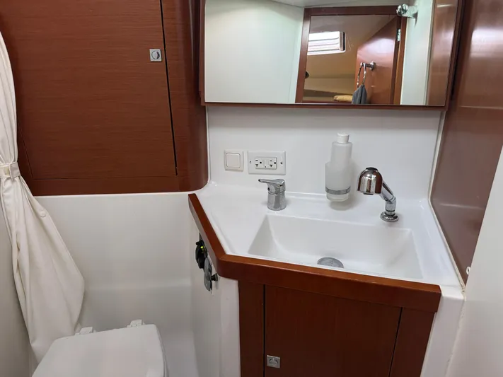 Sol Searcher Yacht Photos Pics Bathroom interior of 2013 Beneteau Oceanis 41 yacht with sink and mirror.