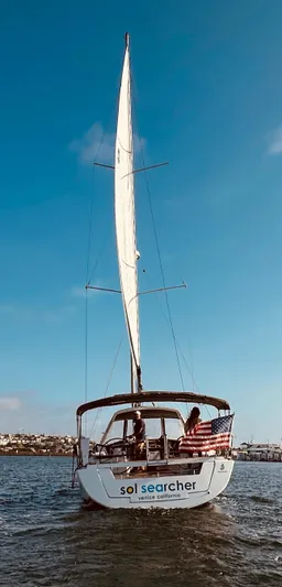 Sol Searcher Yacht Photos Pics Beneteau Oceanis 41 sailboat, 2013 model, sailing on open water under clear blue skies.