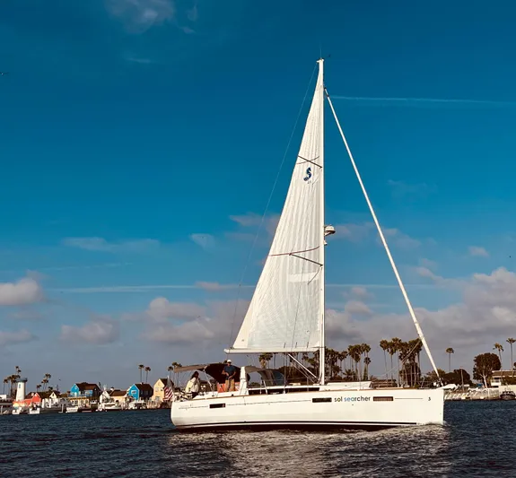 Sol Searcher Yacht Photos Pics 2013 Beneteau Oceanis 41 sailboat cruising on a sunny day with clear blue skies.