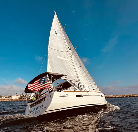 Sol Searcher Yacht Photos Pics 2013 Beneteau Oceanis 41 sailboat cruising on open water under clear blue skies.